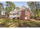 Brick home with multiple decks overlooking the fenced backyard with established trees at 101 Preston Arbor Ln, Cary, NC 27513