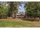 Brick home with decks surrounded by mature trees and green lawn at 101 Preston Arbor Ln, Cary, NC 27513