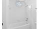 All-white bathroom with a classic tub and shower, accented by a round window at 101 Preston Arbor Ln, Cary, NC 27513