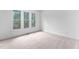 Bright bedroom featuring neutral carpeting and large windows offering natural light at 101 Preston Arbor Ln, Cary, NC 27513