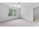 Sunny bedroom featuring neutral carpet and a view from the large window at 101 Preston Arbor Ln, Cary, NC 27513