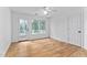 Bright bedroom with hardwood floors, a ceiling fan, and access to the porch at 101 Preston Arbor Ln, Cary, NC 27513