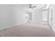 Spacious bedroom with a tray ceiling, ceiling fan, and plenty of natural light at 101 Preston Arbor Ln, Cary, NC 27513