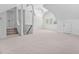 Open bonus room with stairs, fan and ample natural light through windows at 101 Preston Arbor Ln, Cary, NC 27513