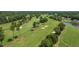 Expansive aerial view of lush golf course with mature trees, sand traps, and smooth green, great for recreation at 101 Preston Arbor Ln, Cary, NC 27513