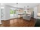 Bright kitchen open to a dining area, featuring an island and access to a covered patio at 101 Preston Arbor Ln, Cary, NC 27513