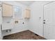 A laundry room with utility sink, cabinets, and tile floors at 101 Preston Arbor Ln, Cary, NC 27513