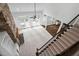 Open living room with a fireplace and views from the top of the stairs at 101 Preston Arbor Ln, Cary, NC 27513