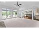 Open-concept living room with views of the kitchen, large windows, and neutral carpet at 101 Preston Arbor Ln, Cary, NC 27513
