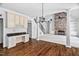 Open-concept living room featuring a stone fireplace, staircase, and hardwood floors at 101 Preston Arbor Ln, Cary, NC 27513