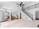 Open floor plan featuring a staircase, living area, and a view into the kitchen with bar seating at 101 Preston Arbor Ln, Cary, NC 27513