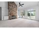 Bright living room features a stone fireplace, built-in shelving, and large windows at 101 Preston Arbor Ln, Cary, NC 27513