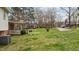 Spacious backyard with a mix of open lawn and mature trees, perfect for outdoor activities at 101 W Thorndale Dr, Oxford, NC 27565