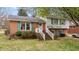 Charming brick and vinyl home featuring a welcoming front porch and well-maintained landscaping at 101 W Thorndale Dr, Oxford, NC 27565