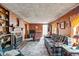 Living room features a fireplace, wood paneling, and a plaid sofa at 101 W Thorndale Dr, Oxford, NC 27565