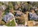 A birdseye view shows well-kept lawns and mature trees enveloping beautiful homes in a suburban setting at 102 Kamprath Pl, Cary, NC 27519
