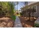Well-manicured backyard with stone pathway, showcasing mature landscaping and the home's exterior at 102 Kamprath Pl, Cary, NC 27519