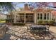 Expansive backyard featuring a covered patio, dining area, lush greenery, and mature trees at 102 Kamprath Pl, Cary, NC 27519
