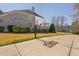 Backyard features a basketball hoop and court, with a rear view of the house featuring a porch at 102 Kamprath Pl, Cary, NC 27519