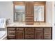 Elegant bathroom featuring double vanity, granite counters, wood cabinets, and modern fixtures at 102 Kamprath Pl, Cary, NC 27519
