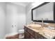 Charming powder room featuring granite counters, hardwood flooring, and stylish vessel sink at 102 Kamprath Pl, Cary, NC 27519