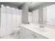 This bathroom features a white vanity with gold hardware, white tile floor, and shower-tub combination at 102 Kamprath Pl, Cary, NC 27519