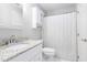 Bright bathroom with granite countertops, a white vanity, and a shower with a curtain, creating a clean and functional space at 102 Kamprath Pl, Cary, NC 27519