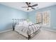 Tranquil bedroom with light blue walls, a decorative iron bed frame, bright window, and soft lighting at 102 Kamprath Pl, Cary, NC 27519