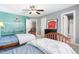 This bedroom features unique Red Sox decor, ceiling fan, and two beds with white comforters at 102 Kamprath Pl, Cary, NC 27519