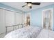 Charming bedroom with blue walls, a decorative iron bed frame, a nearby bathroom, and a view of the staircase at 102 Kamprath Pl, Cary, NC 27519