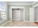 Large walk-in closet with shelving, tiled floor and an open doorway, offering organized storage solutions at 102 Kamprath Pl, Cary, NC 27519