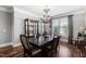 Formal dining room featuring a large wood table, chandelier, and display cabinet at 102 Kamprath Pl, Cary, NC 27519