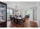 Dining room showcasing hardwood floors, chandelier, and views into the kitchen at 102 Kamprath Pl, Cary, NC 27519