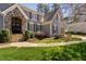 Close-up of the house's entrance showing stone archway, stairs, and manicured bushes at 102 Kamprath Pl, Cary, NC 27519