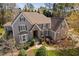 Charming two-story home with a stone archway entrance and well-maintained landscaping at 102 Kamprath Pl, Cary, NC 27519