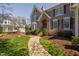 Front view of a house showcasing the stone archway entrance and manicured front yard at 102 Kamprath Pl, Cary, NC 27519