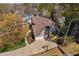 Aerial view of home with mature trees and landscaping, attached three-car garage, and a basketball hoop on the driveway at 102 Kamprath Pl, Cary, NC 27519