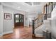 Grand foyer with hardwood floors, a staircase, and a view of the front door at 102 Kamprath Pl, Cary, NC 27519