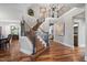 Spacious foyer with hardwood floors, a staircase with black wrought iron railings and views of the upper level at 102 Kamprath Pl, Cary, NC 27519
