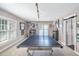 Large game room with ample natural light and space for entertainment, showcasing a ping pong table at 102 Kamprath Pl, Cary, NC 27519