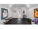 Home gym featuring free weights, pull-up bar, rubber flooring, and framed sport memorabilia at 102 Kamprath Pl, Cary, NC 27519