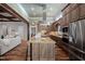 Open-concept kitchen with large island, stainless steel appliances, and custom cabinetry at 102 Kamprath Pl, Cary, NC 27519