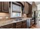 Gourmet kitchen featuring custom cabinetry, granite countertops, and stainless steel appliances at 102 Kamprath Pl, Cary, NC 27519