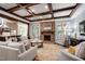 Cozy living room with stone fireplace, wood beams, and comfortable seating at 102 Kamprath Pl, Cary, NC 27519