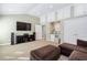 Spacious living room area with carpet flooring, TV, built-in storage and seating for entertaining guests at 102 Kamprath Pl, Cary, NC 27519