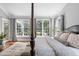 Comfortable main bedroom featuring hardwood flooring, large windows and neutral color palette at 102 Kamprath Pl, Cary, NC 27519