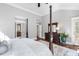 Spacious main bedroom featuring four poster bed, hardwood flooring, and en suite bathroom at 102 Kamprath Pl, Cary, NC 27519