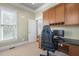 A well-lit office with built-in wooden cabinets, desk, and a comfortable gaming chair, perfect for work and play at 102 Kamprath Pl, Cary, NC 27519