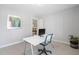 Bright home office featuring neutral walls, white trim, modern desk, large window, and neutral carpet at 102 Kamprath Pl, Cary, NC 27519