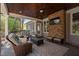 Relaxing covered outdoor patio with wicker furniture, a stone fireplace, ceiling fan and television at 102 Kamprath Pl, Cary, NC 27519